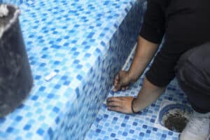 man performing pool renovations in the winter