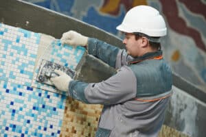 worker completing pool renovations