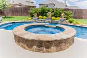 completed pool renovation and hot tub in backyard