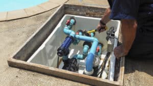 pool tech working on pool equipment