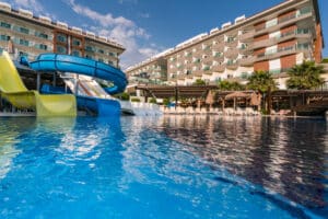 commercial pool with a slide at a hotel resort